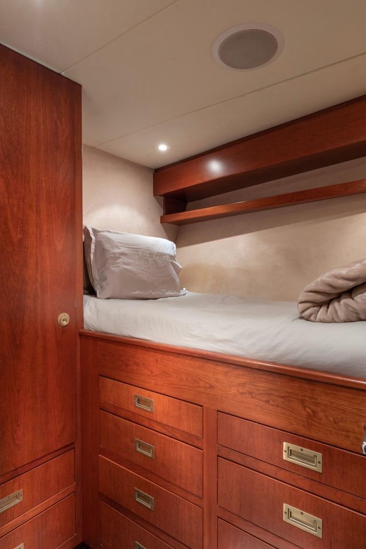 a bed with a wooden headboard aboard SIMARON Yacht for Sale