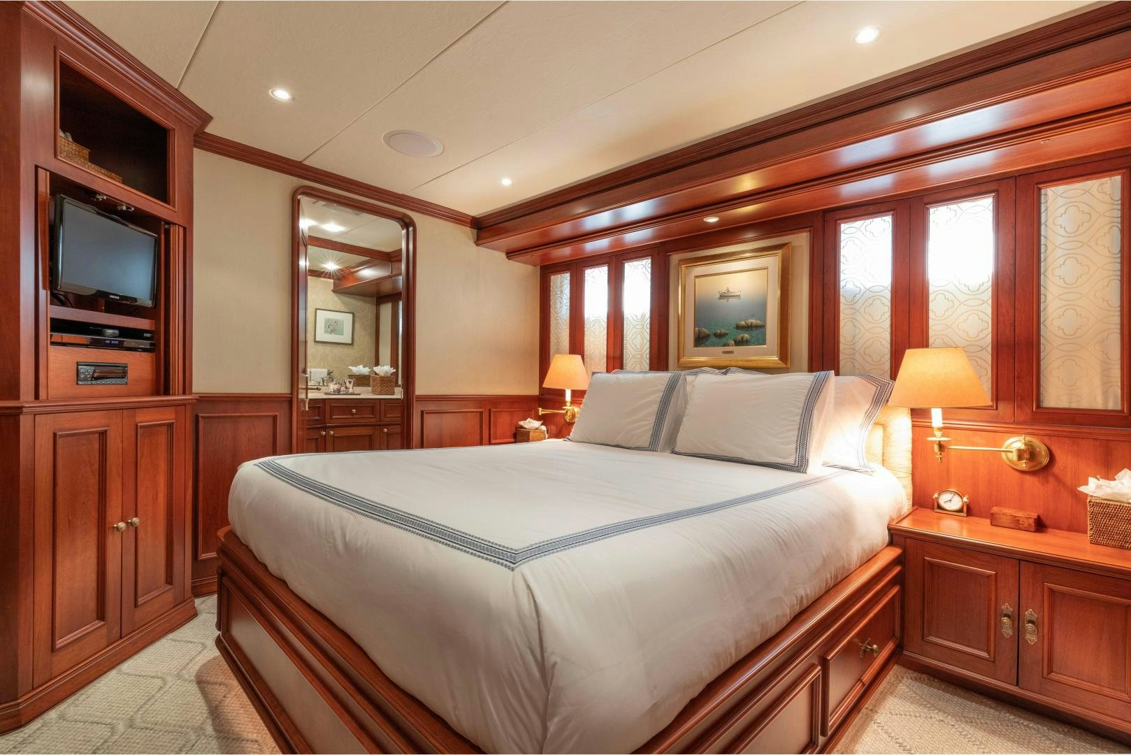 a bedroom with a bed and a television aboard SIMARON Yacht for Sale