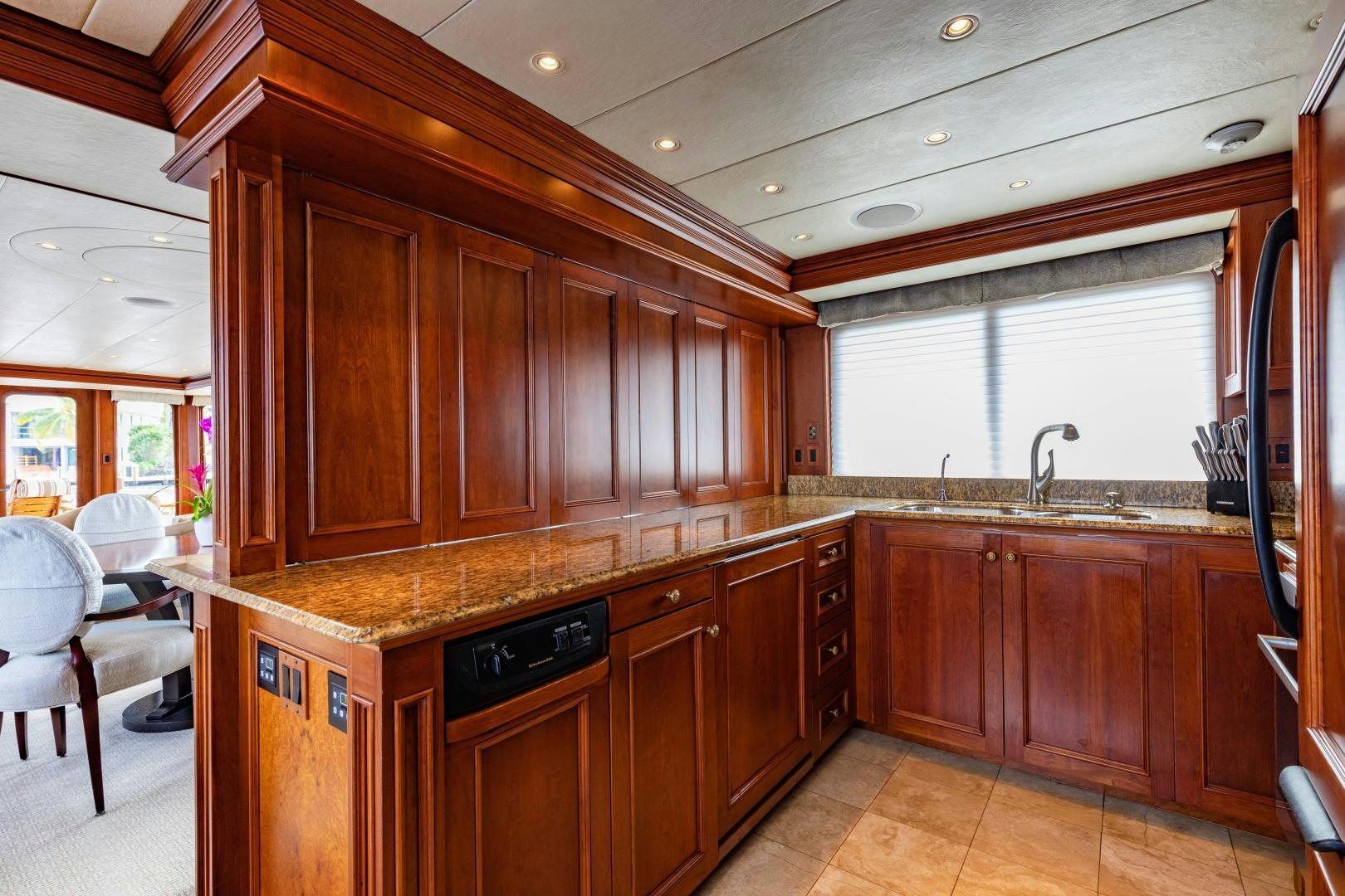 a kitchen with wooden cabinets aboard SIMARON Yacht for Sale