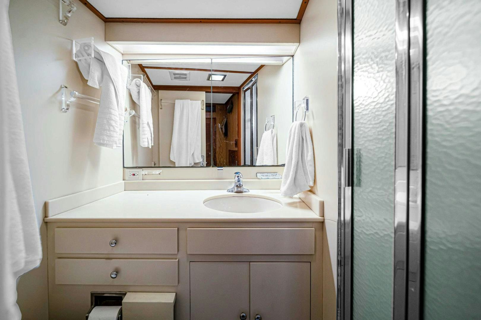 a bathroom with a sink and a mirror aboard INEVITABLE Yacht for Sale