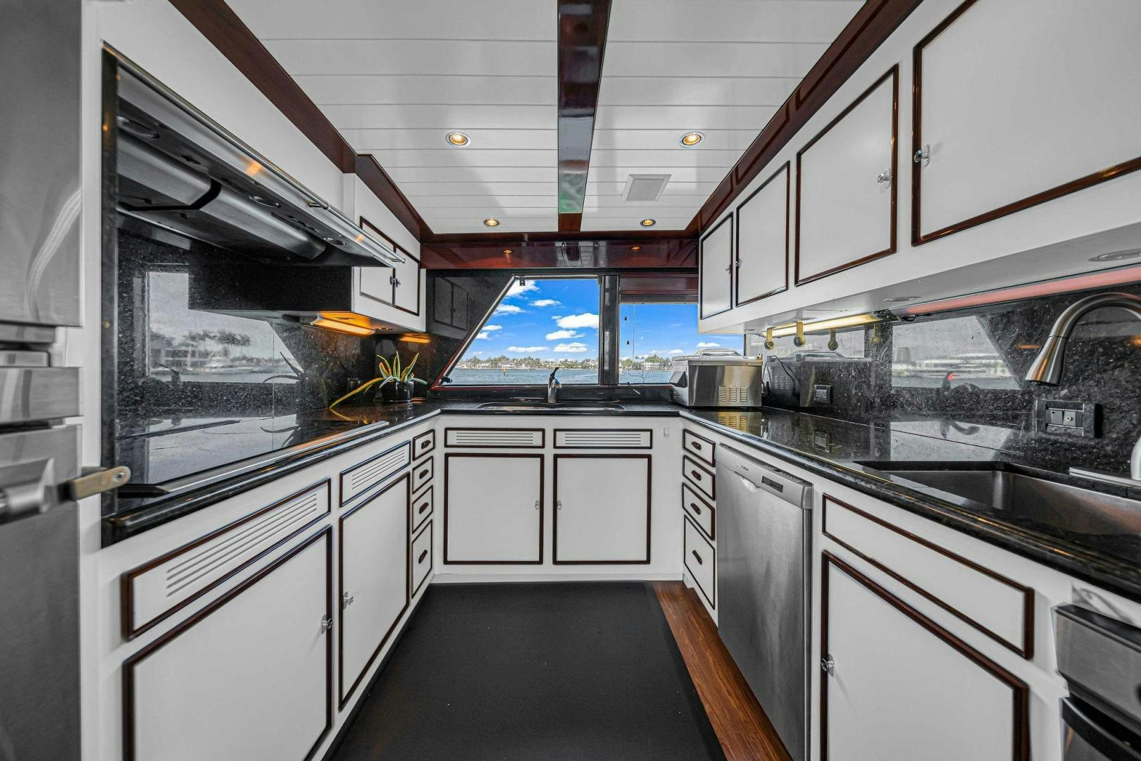 a kitchen with white cabinets aboard INEVITABLE Yacht for Sale