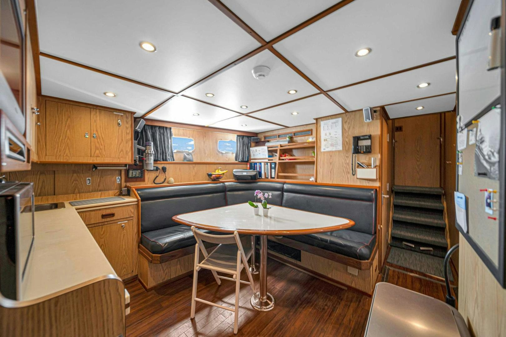 a kitchen with a dining table aboard INEVITABLE Yacht for Sale