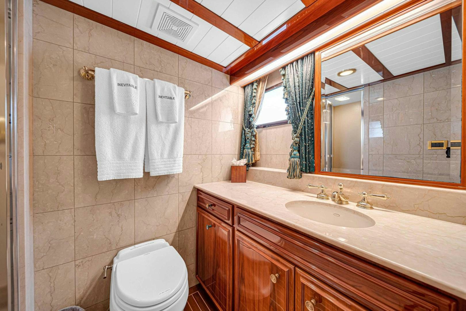 a bathroom with a sink and a toilet aboard INEVITABLE Yacht for Sale