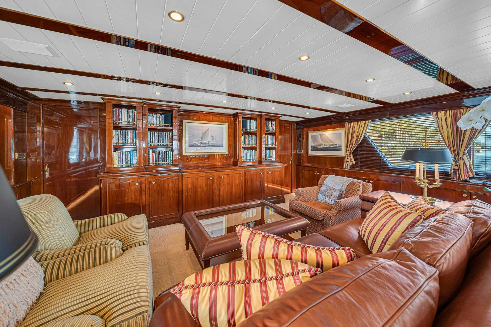 a living room with a large wood wall aboard INEVITABLE Yacht for Sale