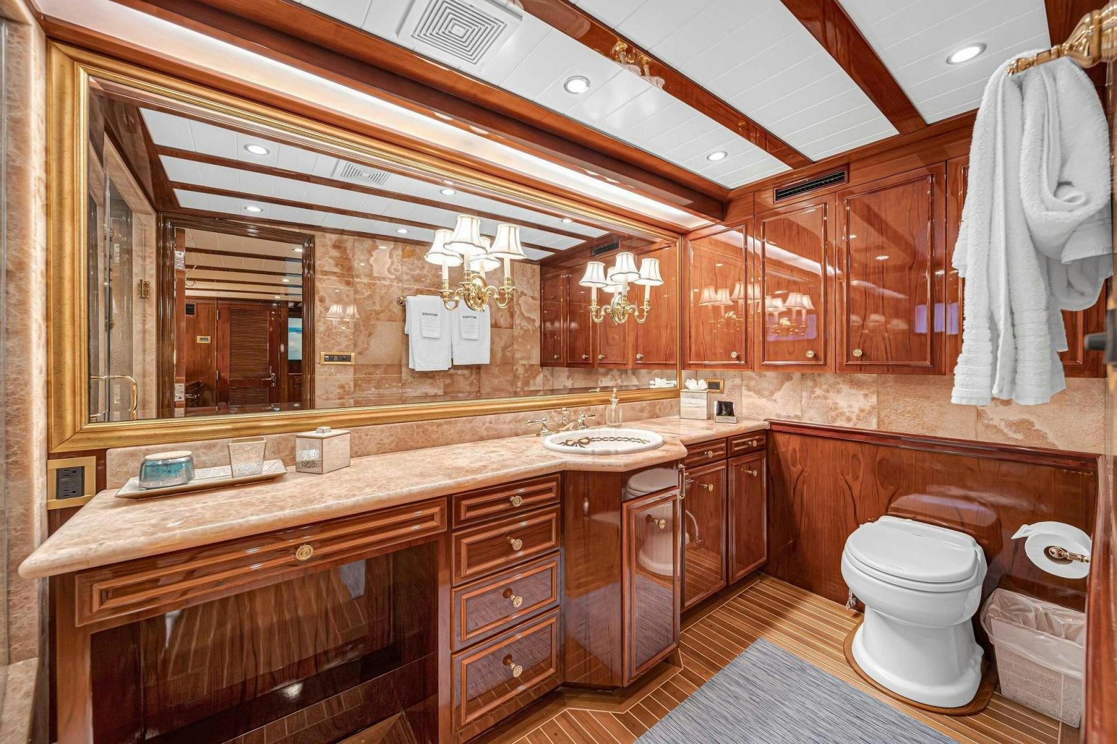 a bathroom with wooden cabinets aboard INEVITABLE Yacht for Sale