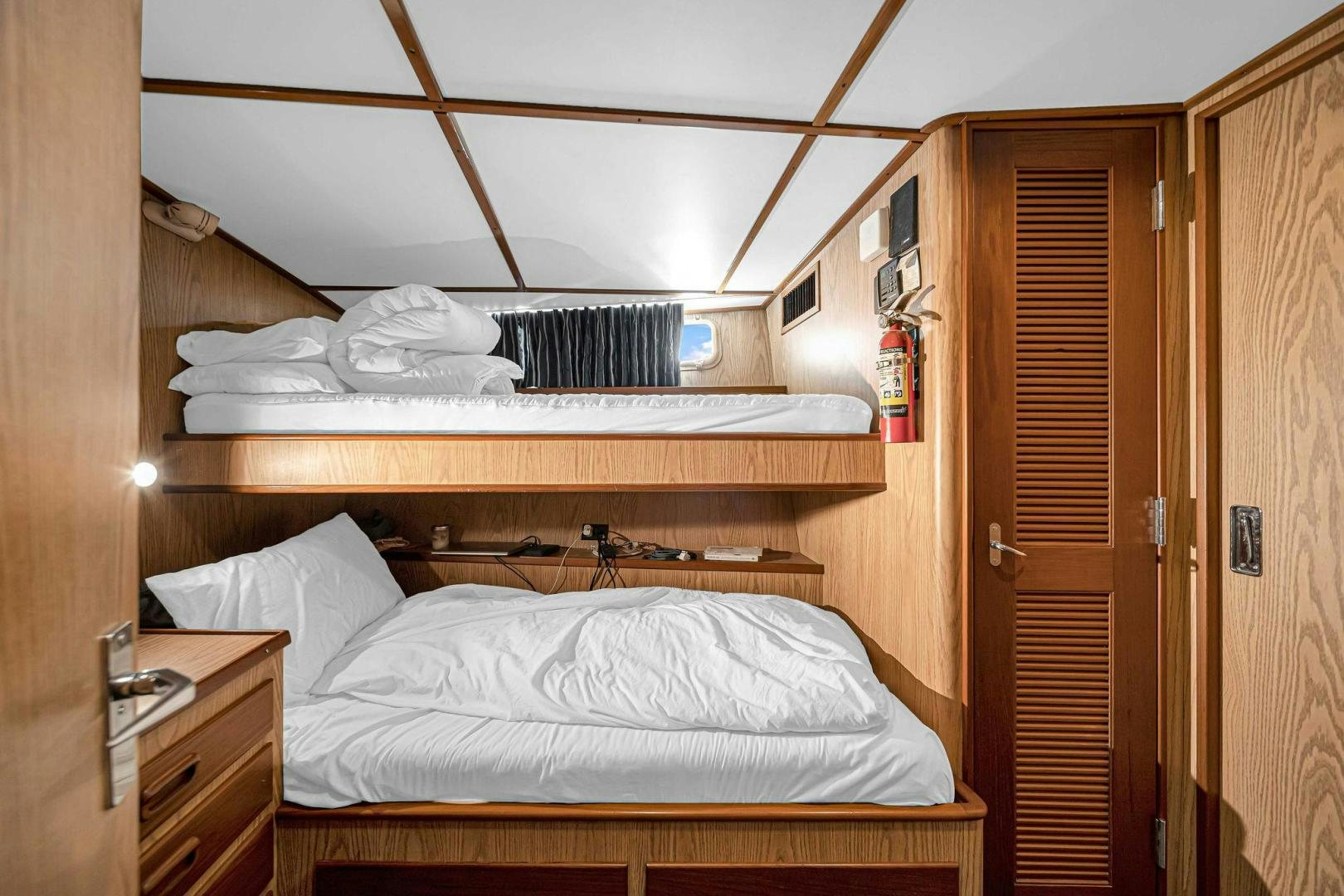 a room with a bed and a closet aboard INEVITABLE Yacht for Sale
