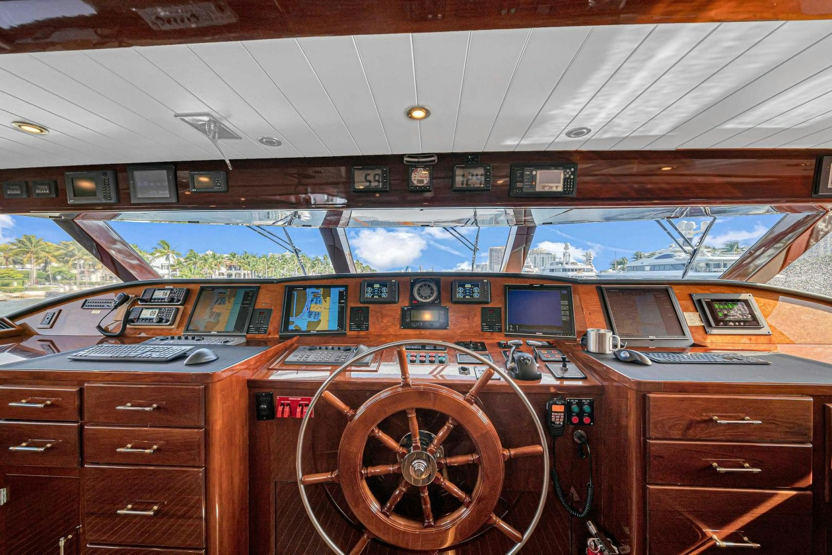 a wooden cabin with a large wooden wheel and a large wooden wheel aboard INEVITABLE Yacht for Sale