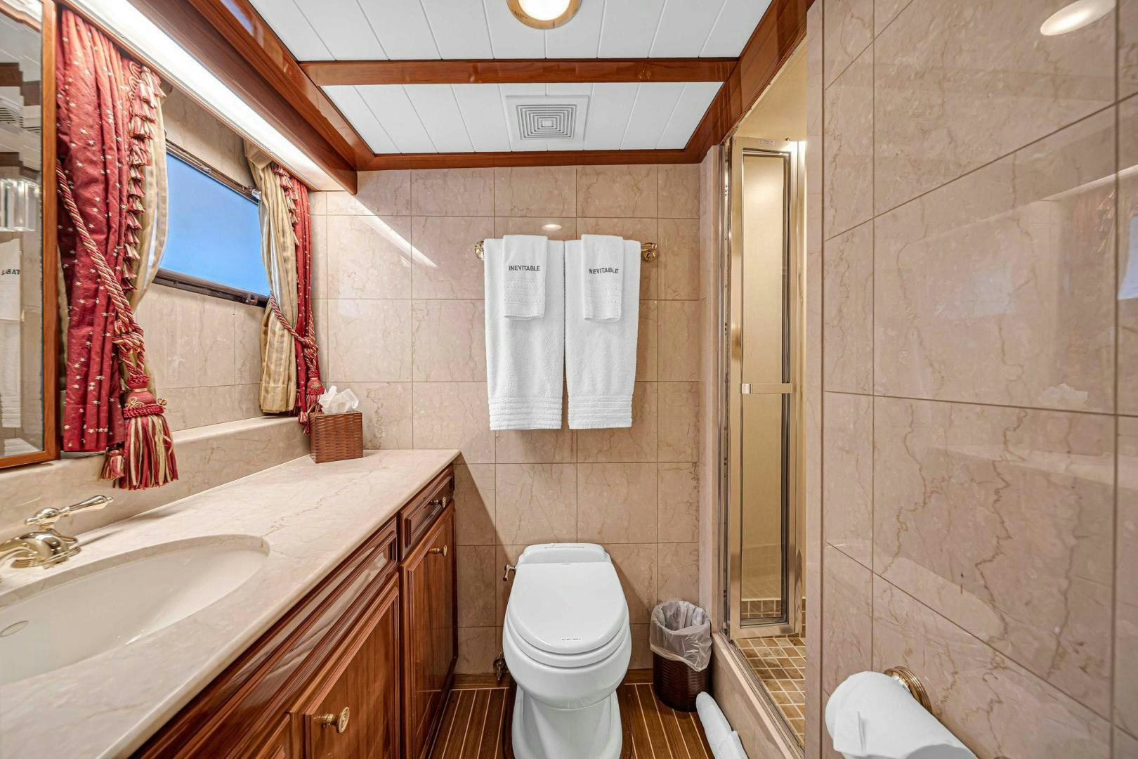 a bathroom with a toilet sink and a mirror aboard INEVITABLE Yacht for Sale