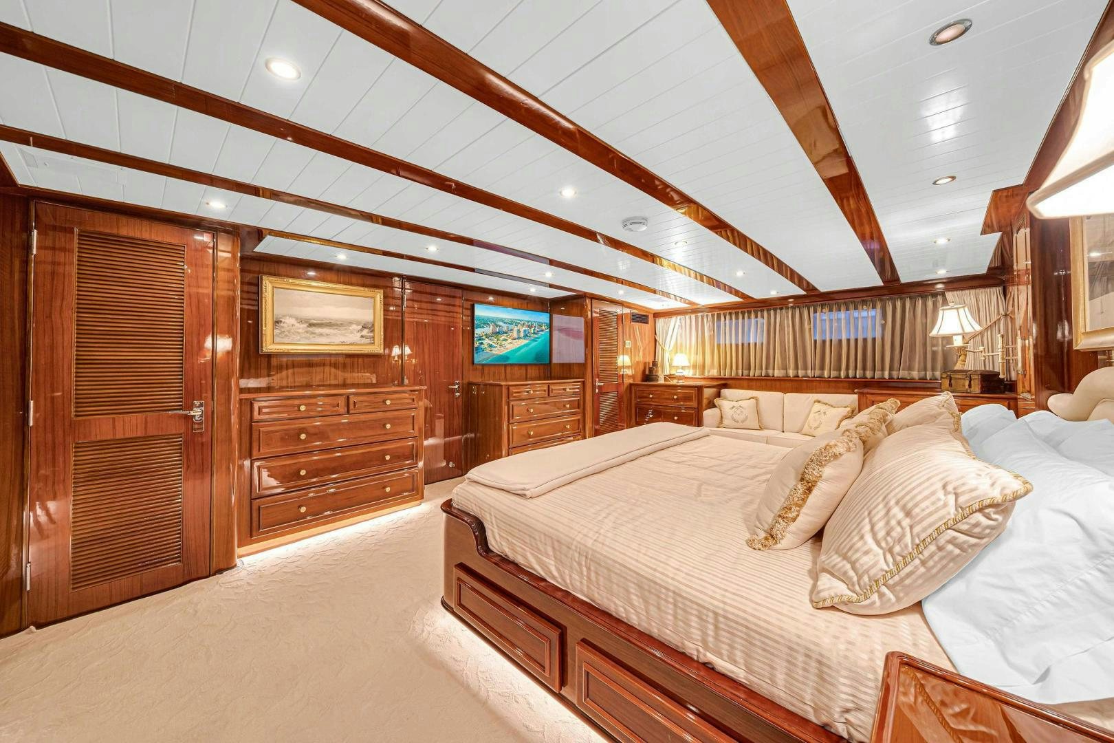 a room with a bed and a wood wall aboard INEVITABLE Yacht for Sale