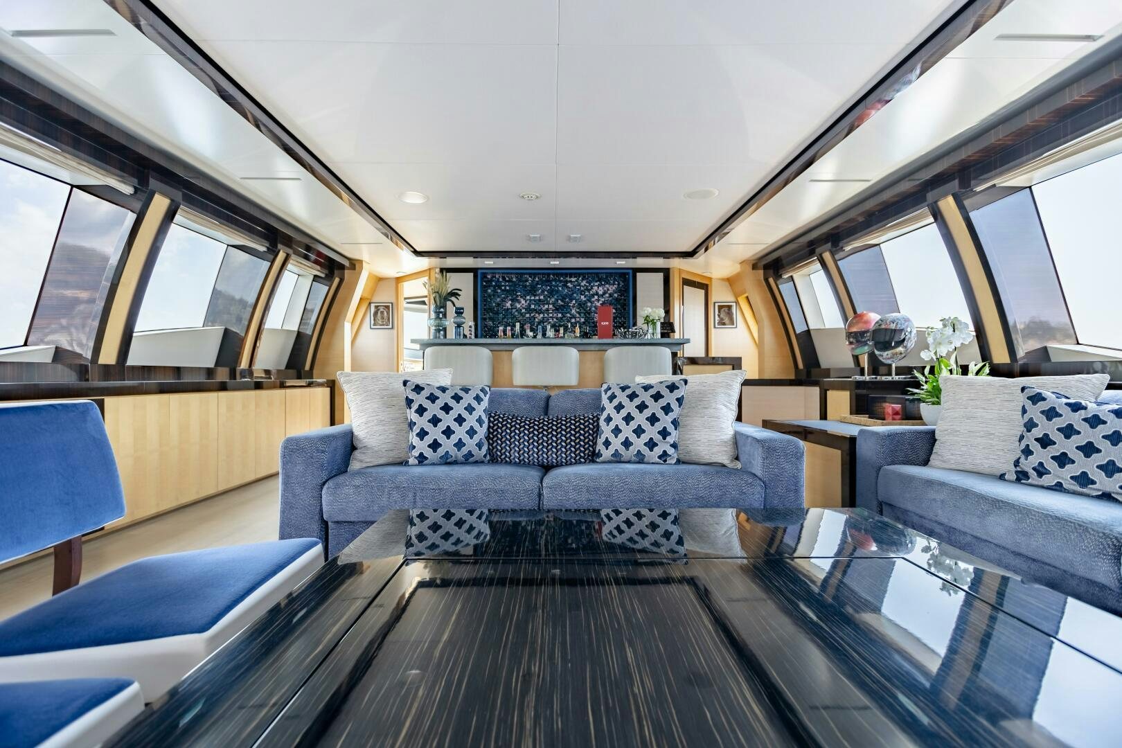 a living room with a large sofa aboard KJOS Yacht for Sale
