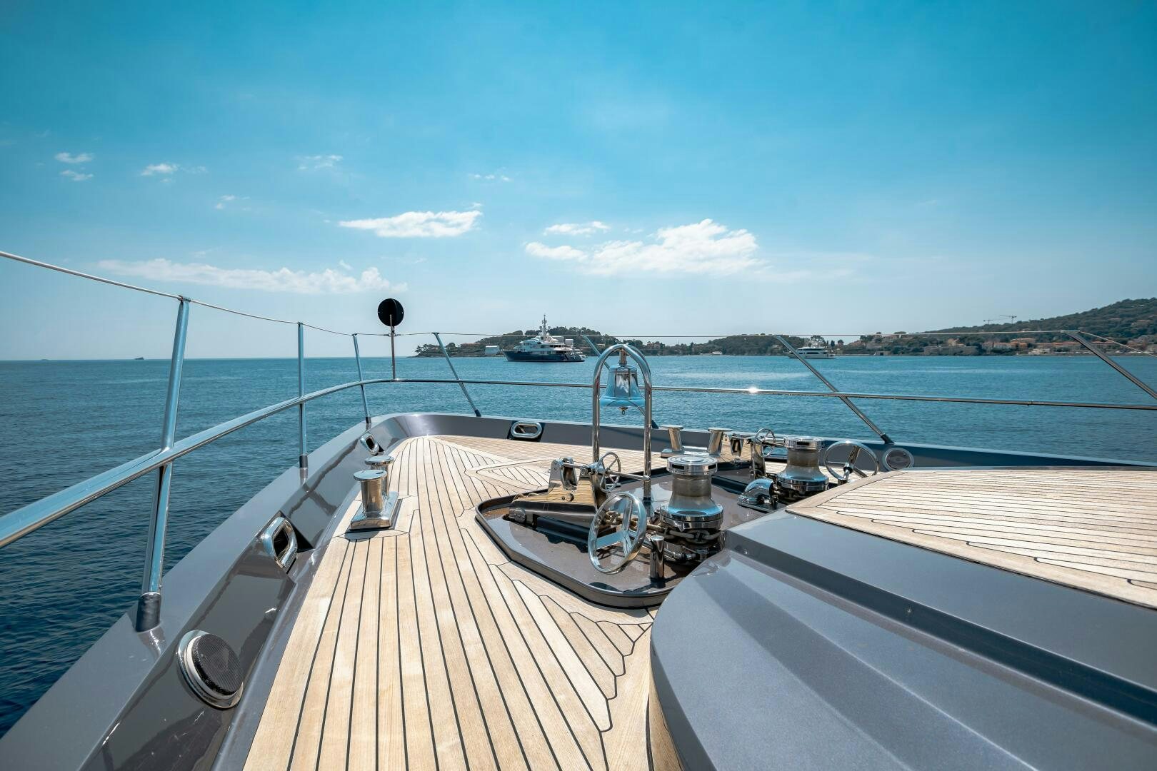 a deck with a deck and a view of the water and boats aboard KJOS Yacht for Sale