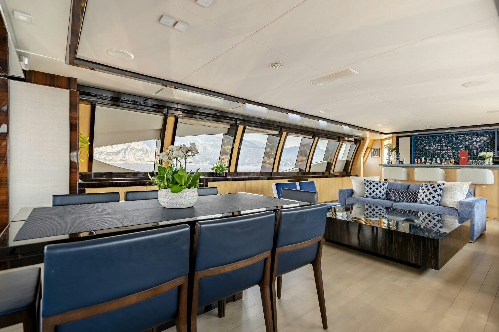 a large room with a pool table and chairs aboard KJOS Yacht for Sale