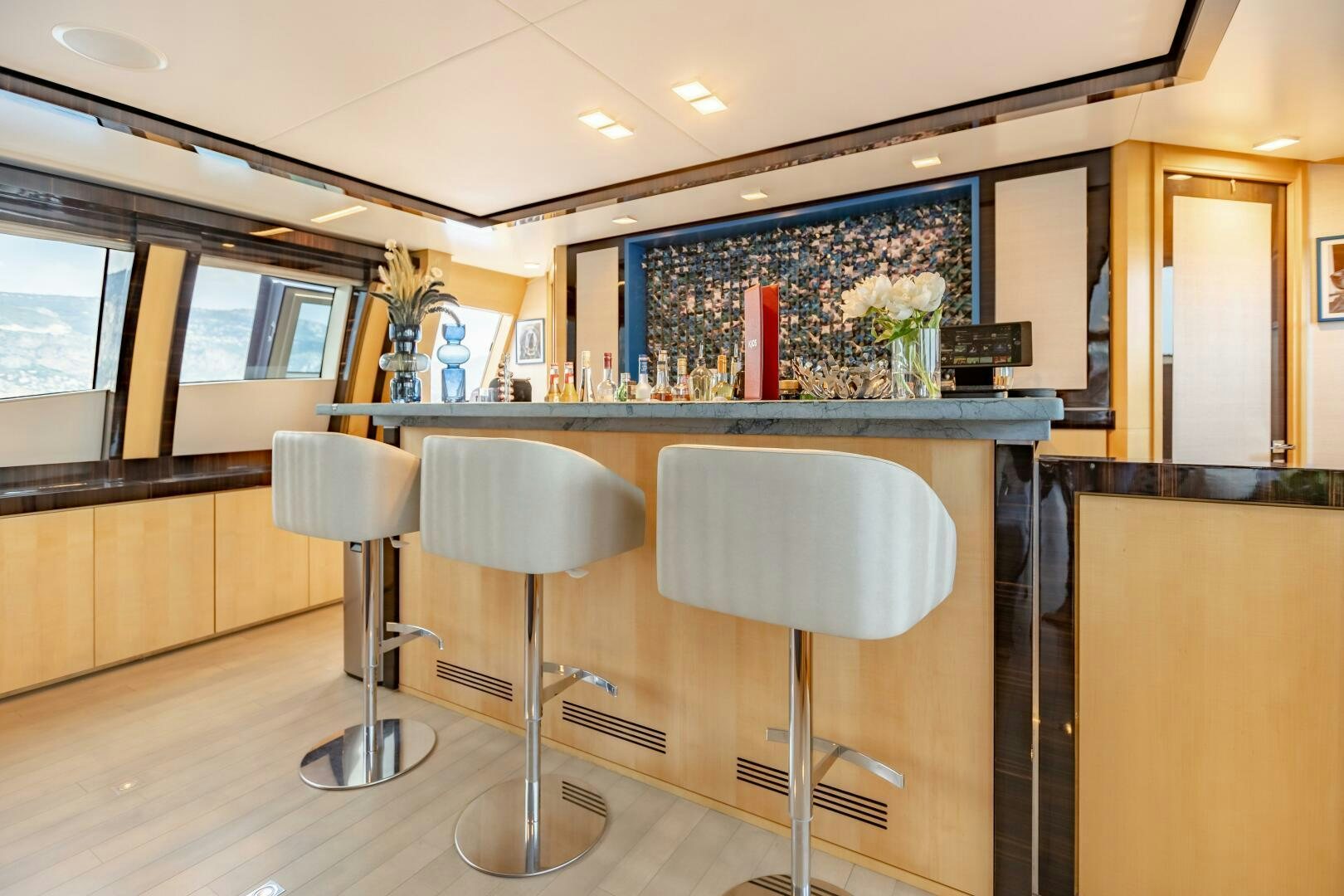 a bar with stools and stools aboard KJOS Yacht for Sale