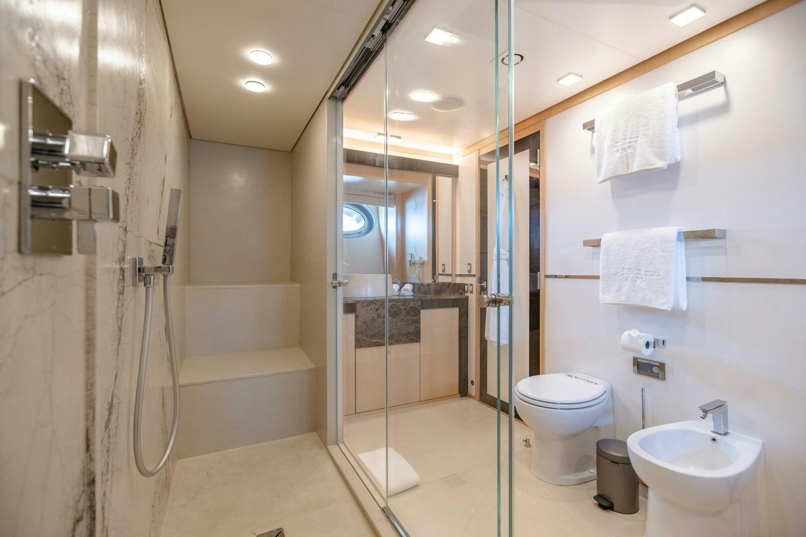 a bathroom with a glass shower aboard KJOS Yacht for Sale