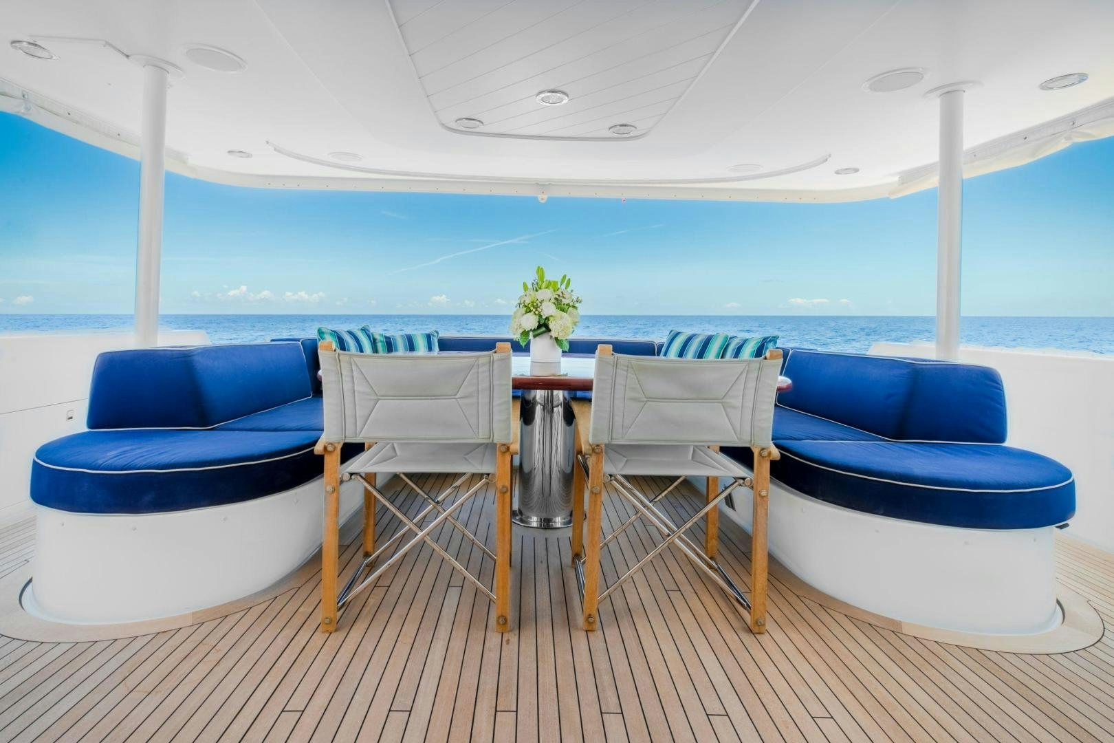 a table and chairs on a deck aboard CHECKERED PAST Yacht for Sale