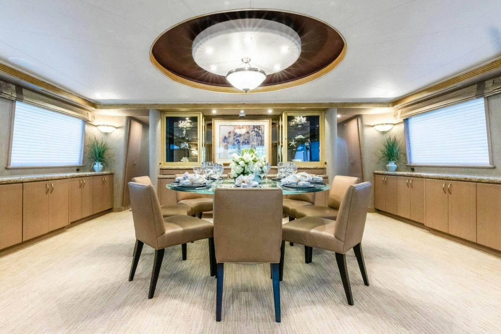 a dining room with a table and chairs aboard CHECKERED PAST Yacht for Sale