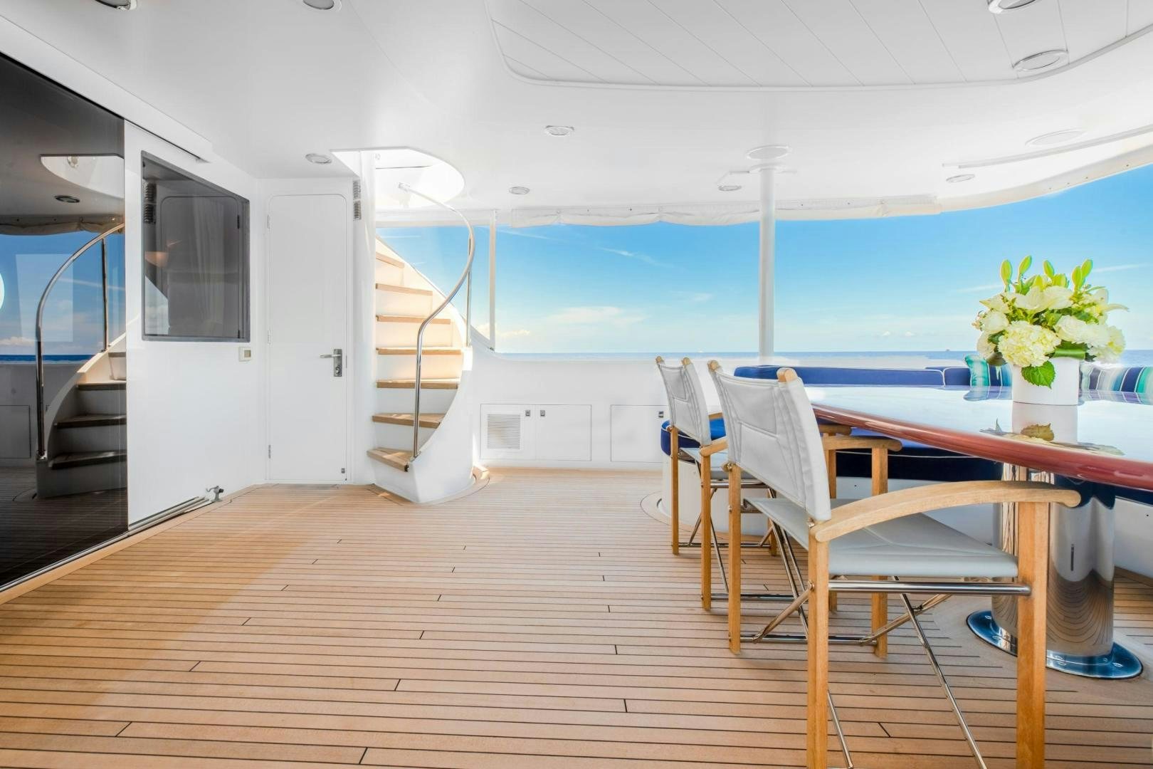 a room with a table and chairs aboard CHECKERED PAST Yacht for Sale