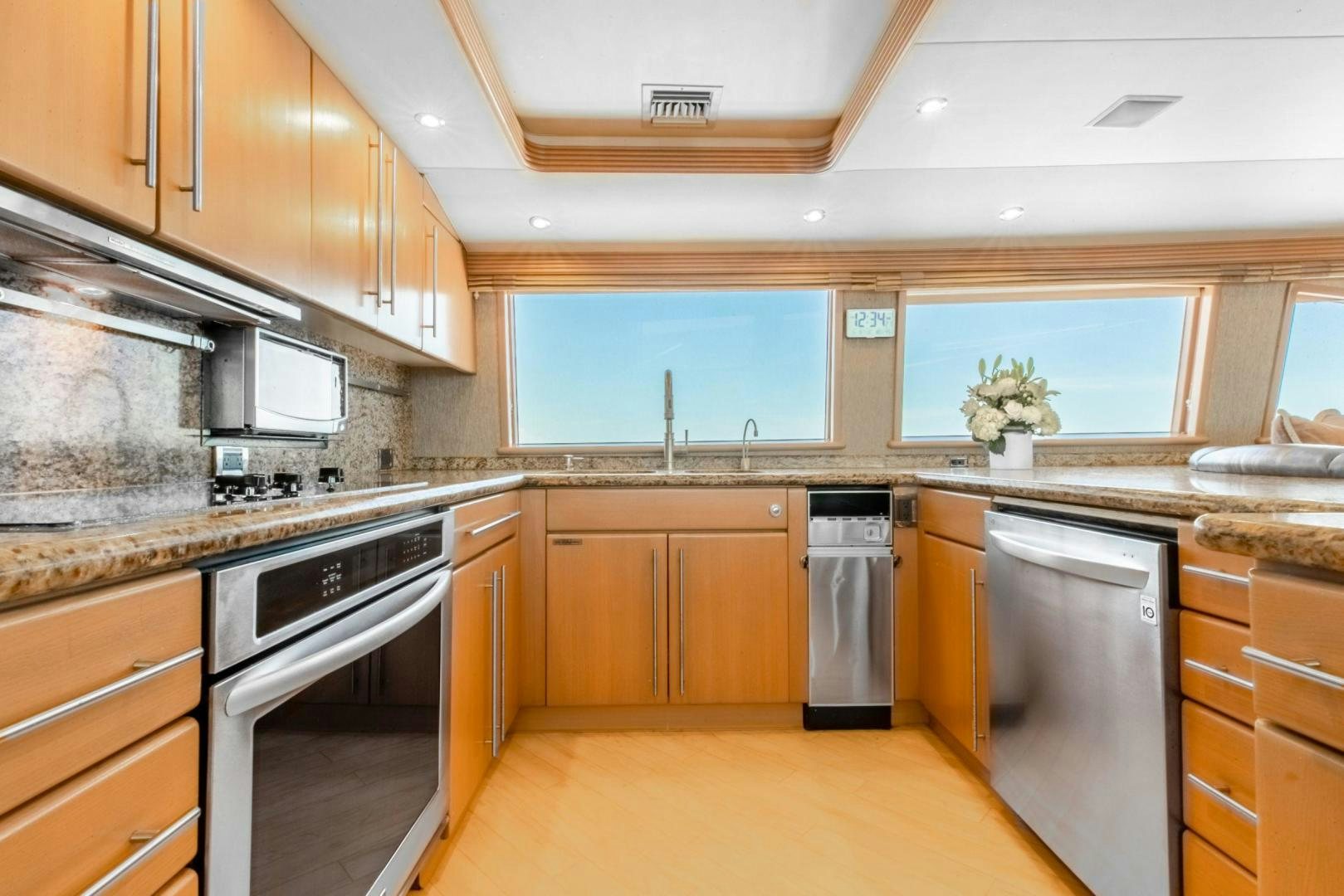 a kitchen with wooden cabinets aboard CHECKERED PAST Yacht for Sale