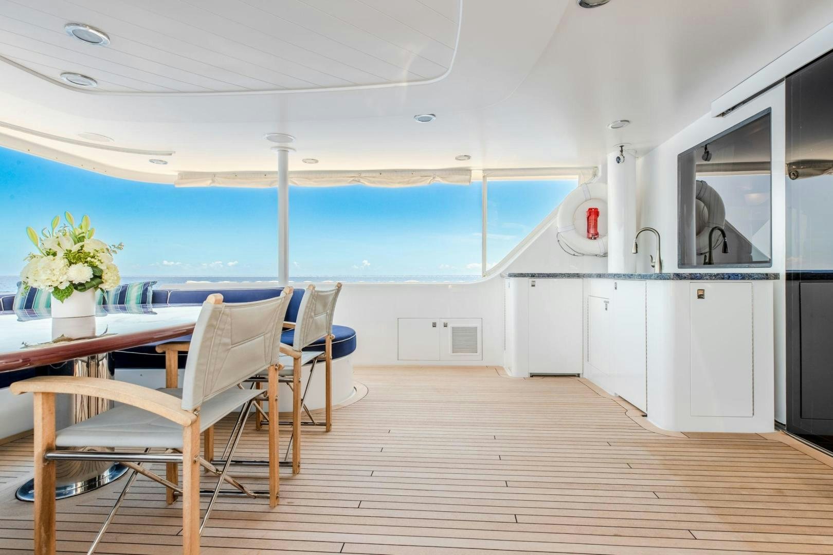 a room with a table and chairs aboard CHECKERED PAST Yacht for Sale