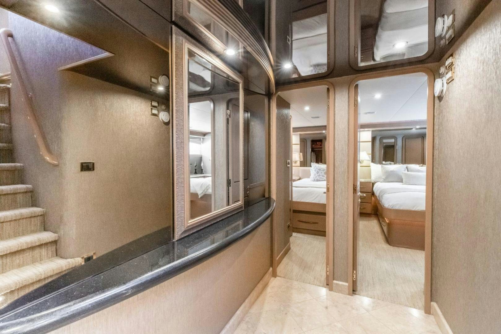 a room with a bed and a mirror aboard CHECKERED PAST Yacht for Sale