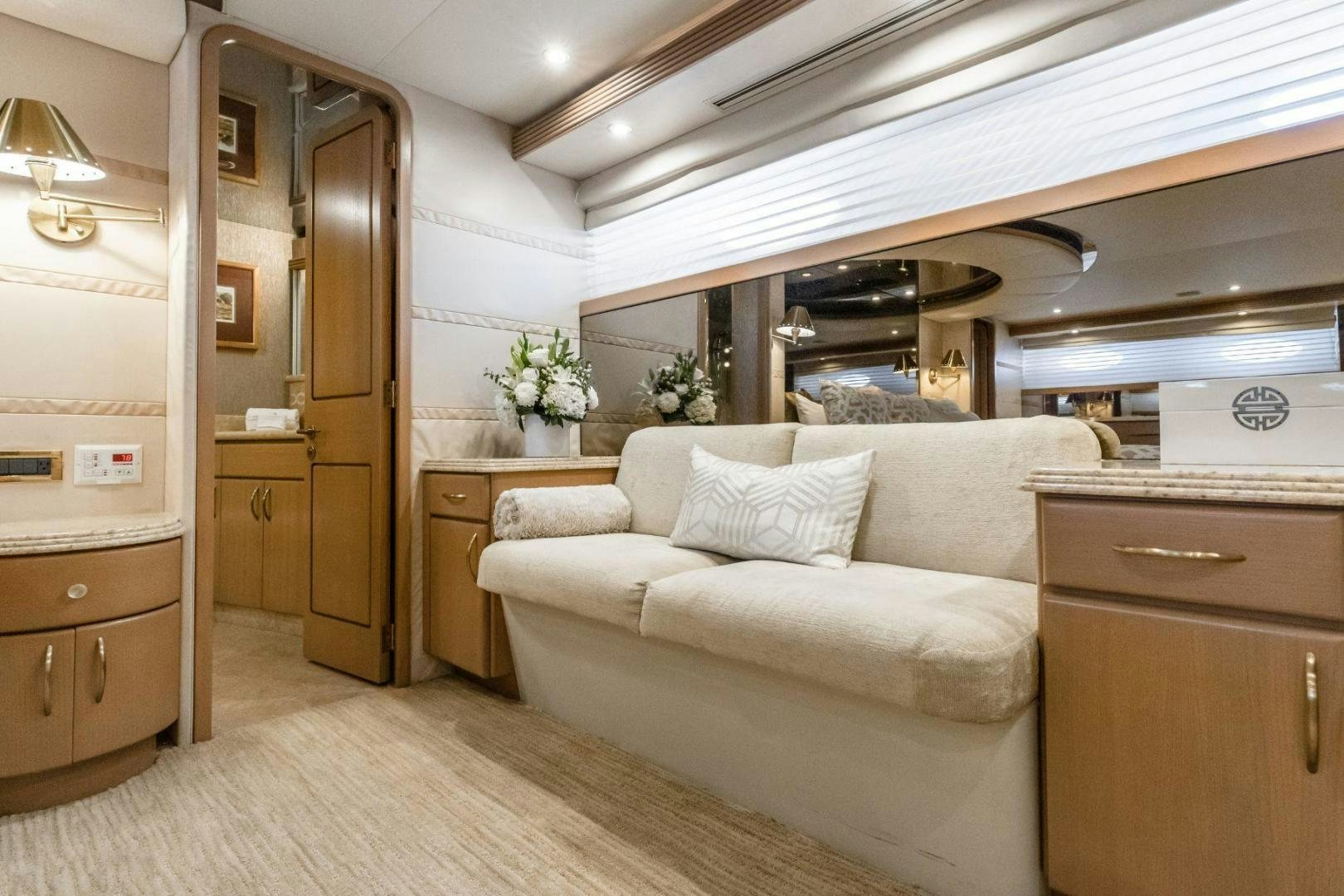 a room with a couch and a wood door aboard CHECKERED PAST Yacht for Sale