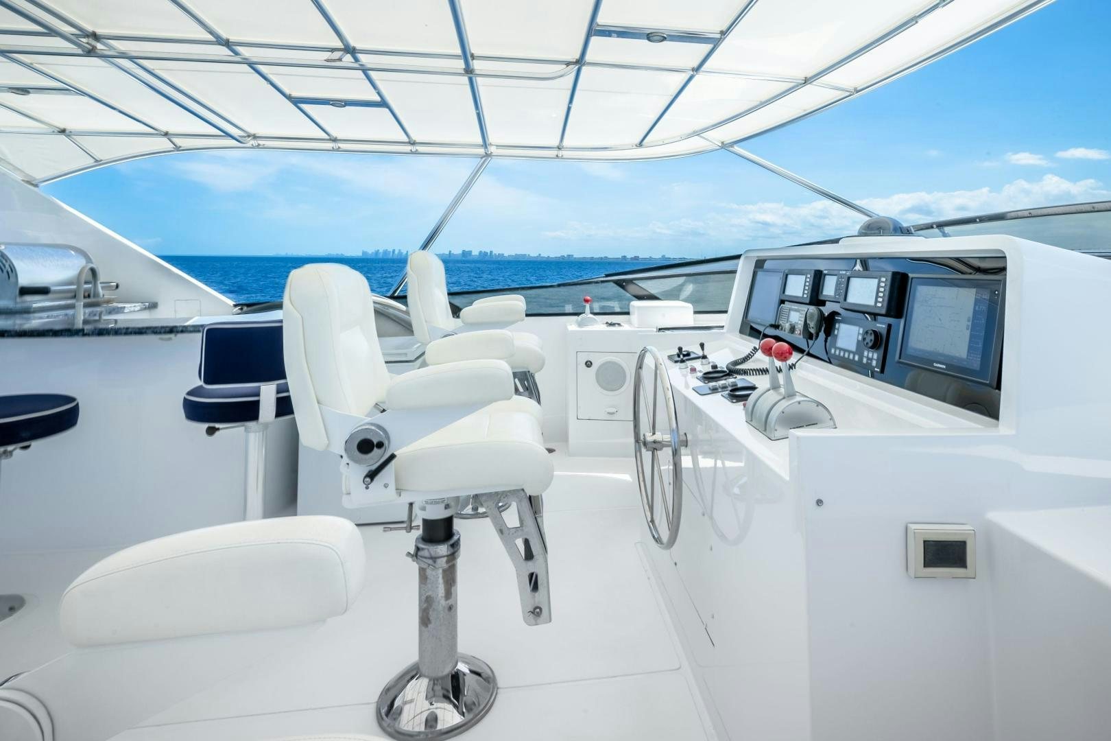 a white airplane with chairs and a table on the front aboard CHECKERED PAST Yacht for Sale