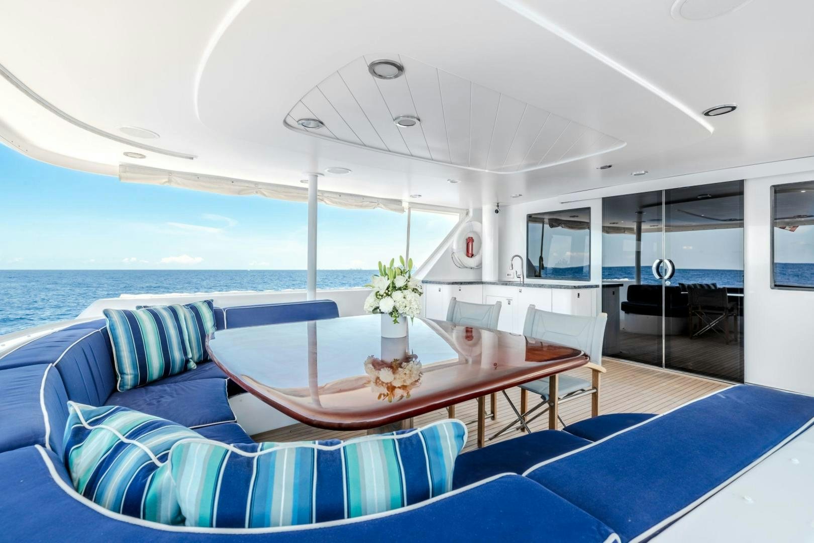 a boat with a table and chairs aboard CHECKERED PAST Yacht for Sale