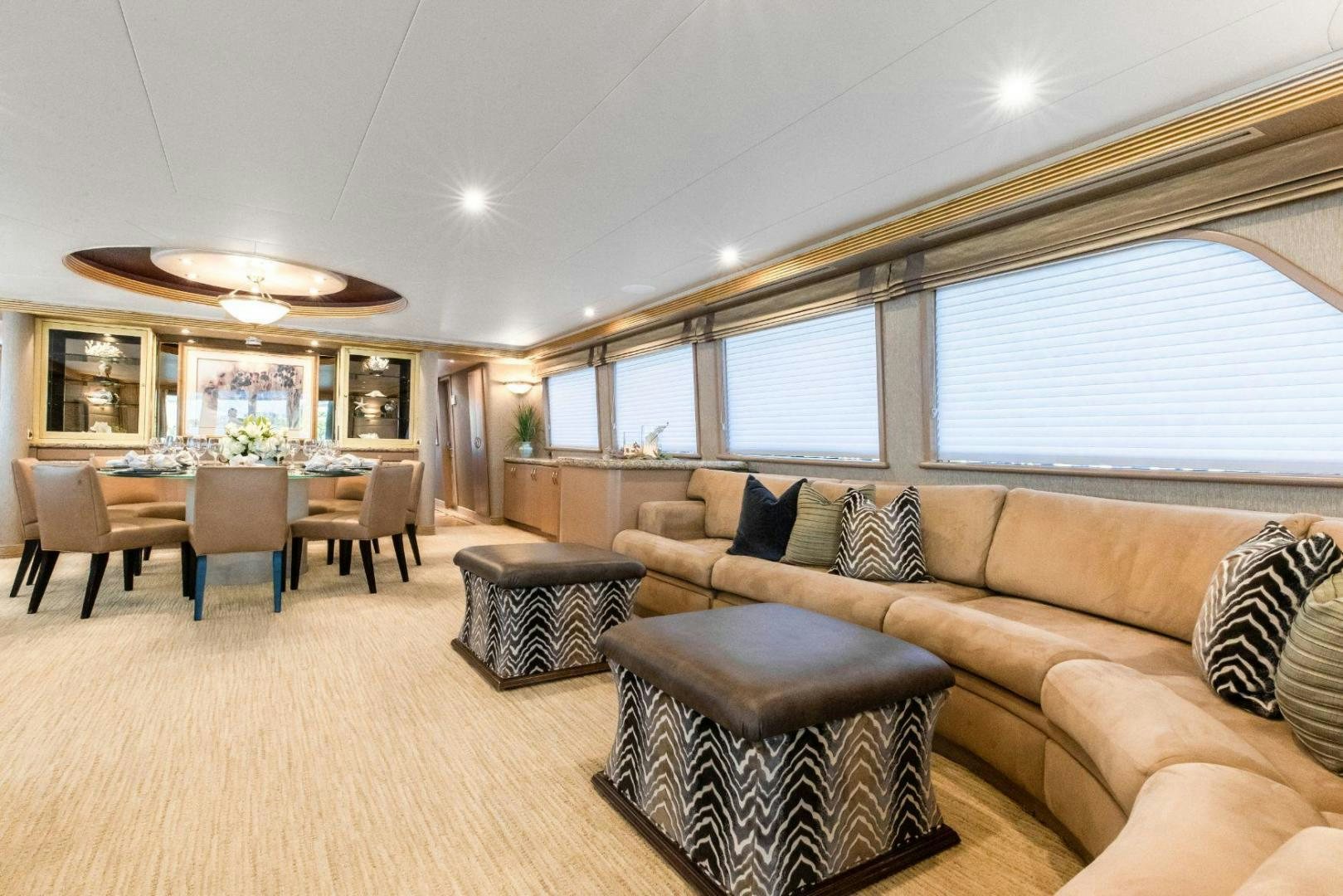 a living room with a couch and a table aboard CHECKERED PAST Yacht for Sale