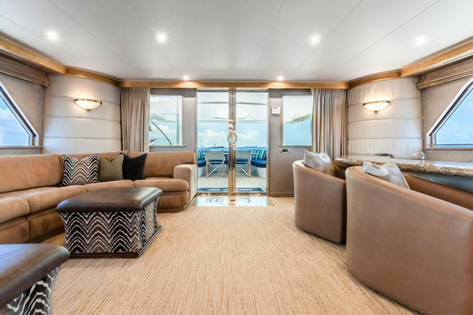 a living room with a large glass door aboard CHECKERED PAST Yacht for Sale