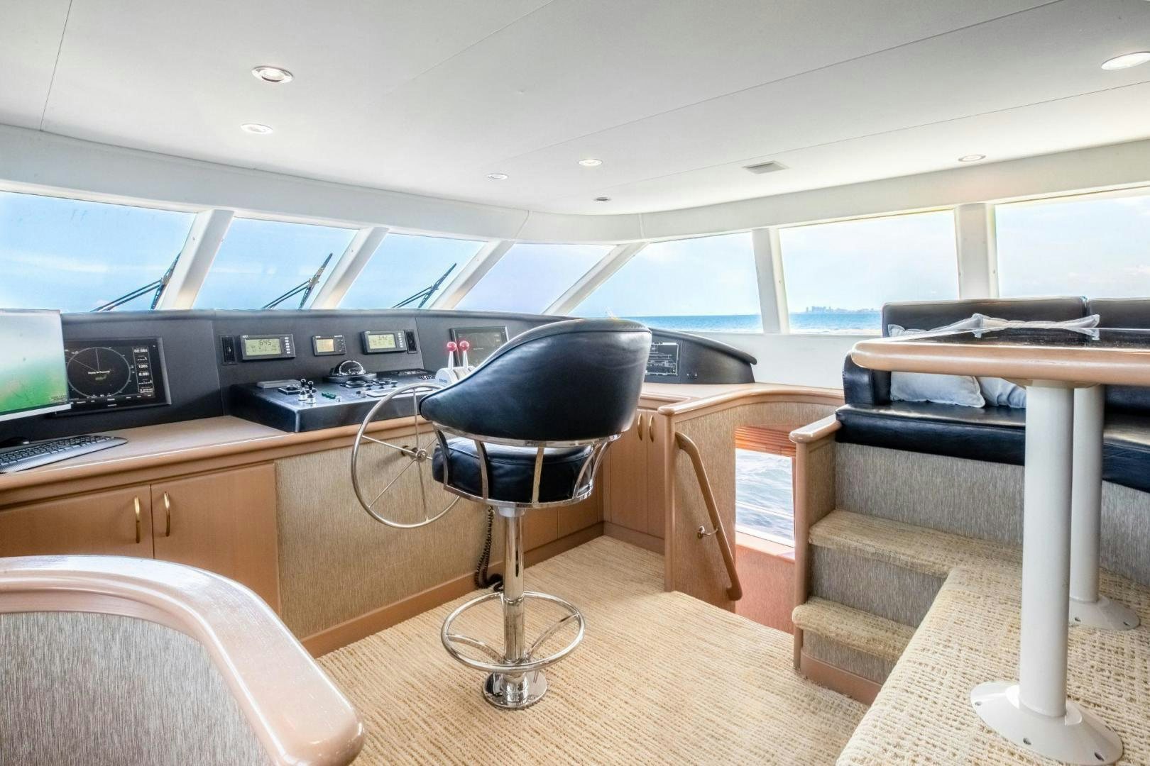 a room with a desk and chairs aboard CHECKERED PAST Yacht for Sale