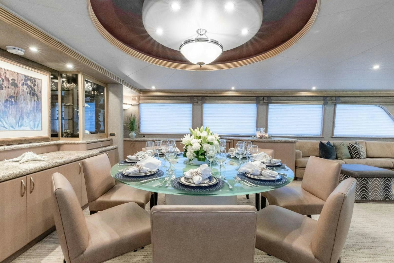 a dining room with a large window aboard CHECKERED PAST Yacht for Sale