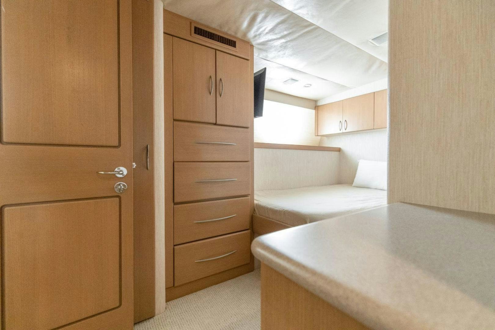 a room with a bed and a desk aboard CHECKERED PAST Yacht for Sale