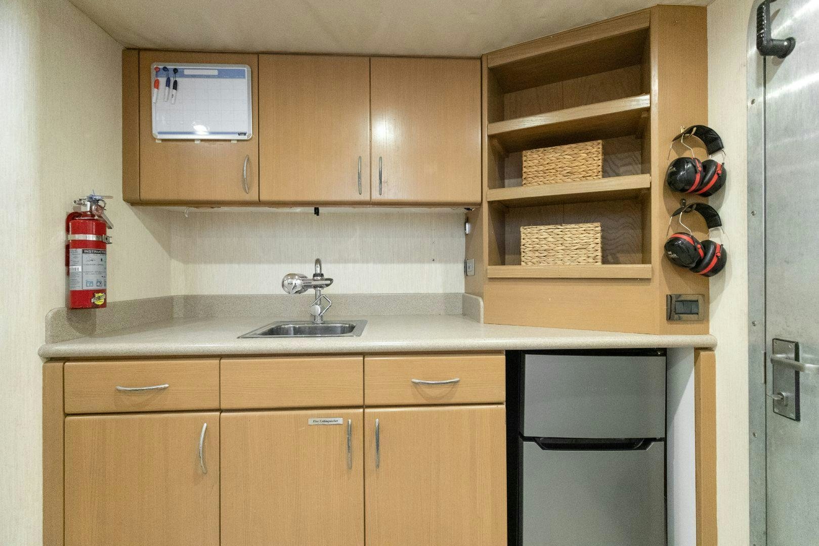 a kitchen with wooden cabinets aboard CHECKERED PAST Yacht for Sale