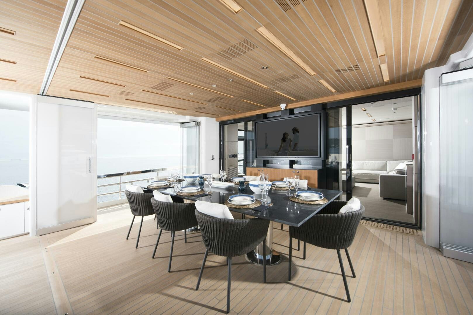 a large room with a table and chairs aboard PICCOLO Yacht for Sale