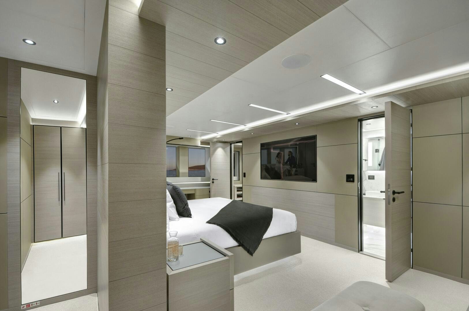 a room with a bed and a desk aboard PICCOLO Yacht for Sale