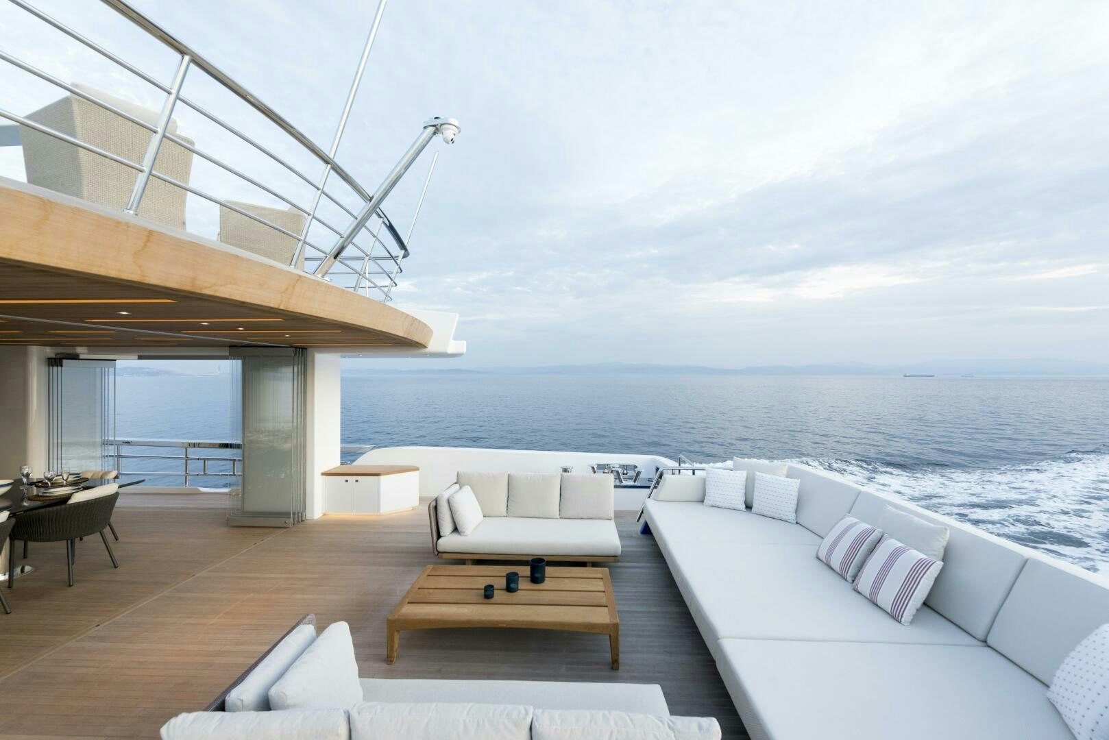 a room with a couch and a table and a view of the ocean aboard PICCOLO Yacht for Sale