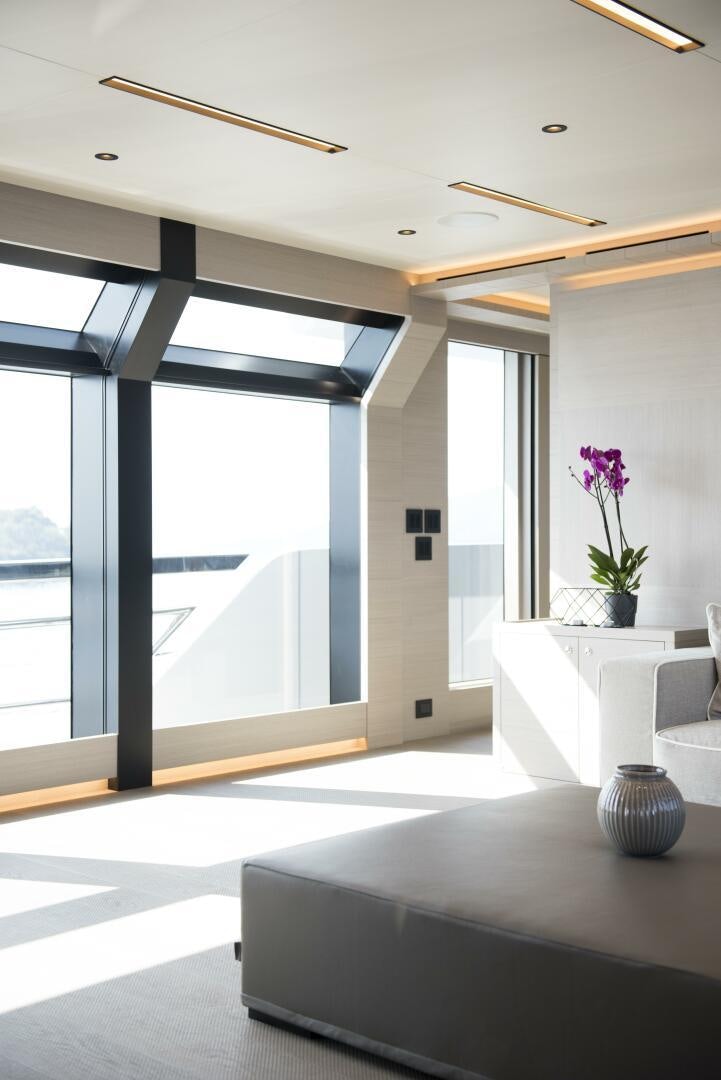 a room with a table and a vase with flowers in it aboard PICCOLO Yacht for Sale