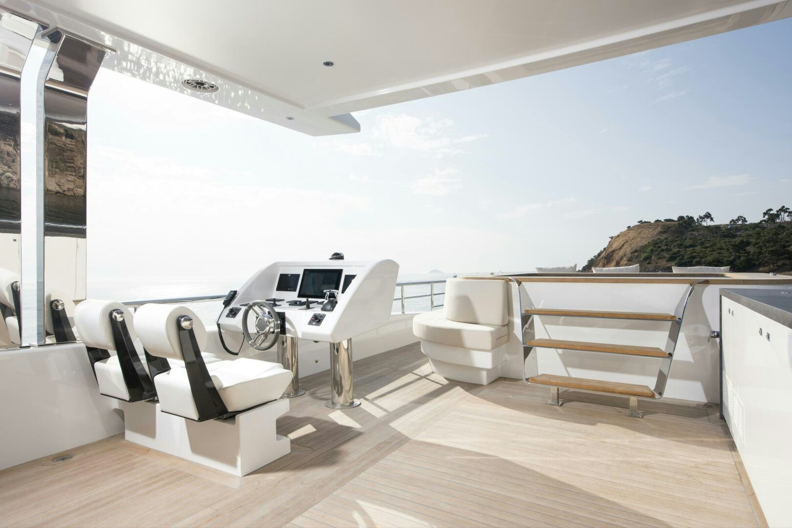 a white lounge chair on a deck aboard PICCOLO Yacht for Sale