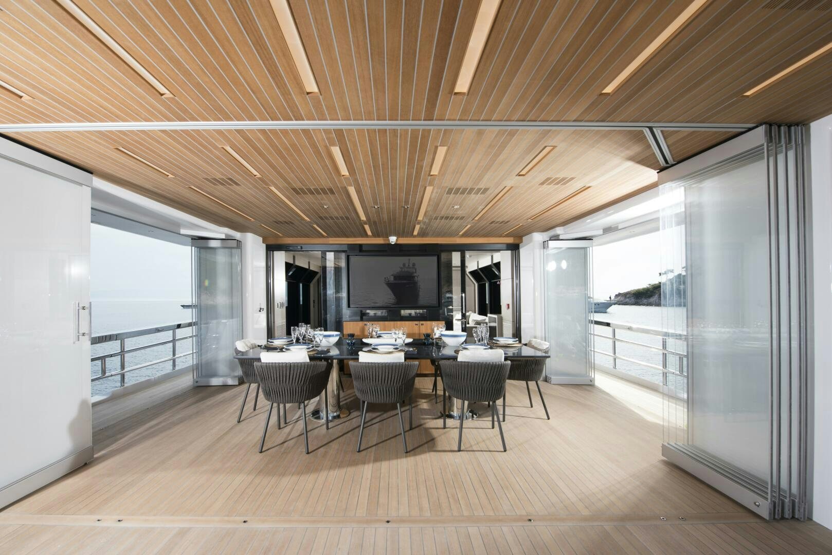 a room with a table and chairs aboard PICCOLO Yacht for Sale