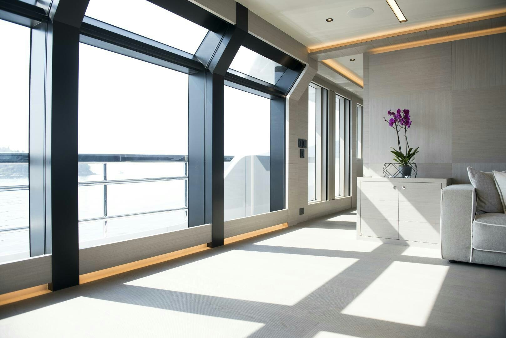 a room with a large window and a couch aboard PICCOLO Yacht for Sale