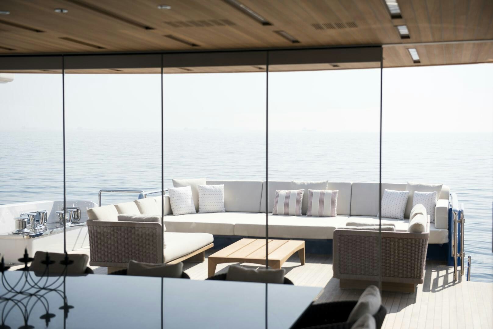 a room with a couch and a table and a large window aboard PICCOLO Yacht for Sale