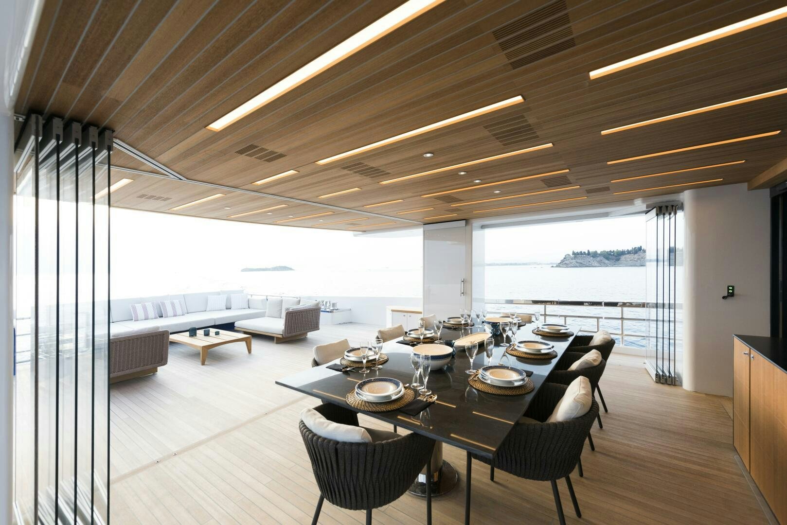 a large room with a table and chairs aboard PICCOLO Yacht for Sale