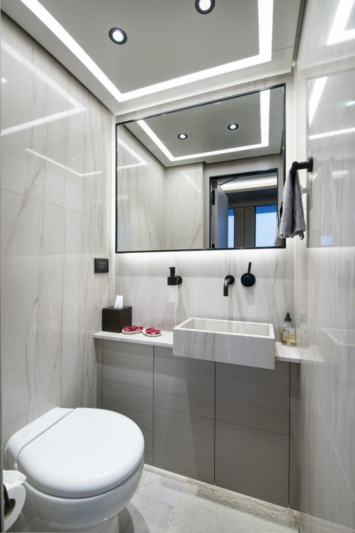 a bathroom with a tub sink and toilet aboard PICCOLO Yacht for Sale