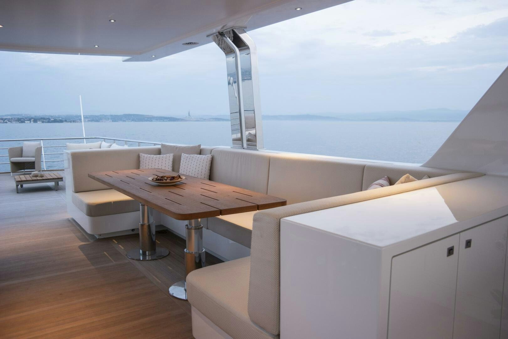 a room with a table and chairs aboard PICCOLO Yacht for Sale