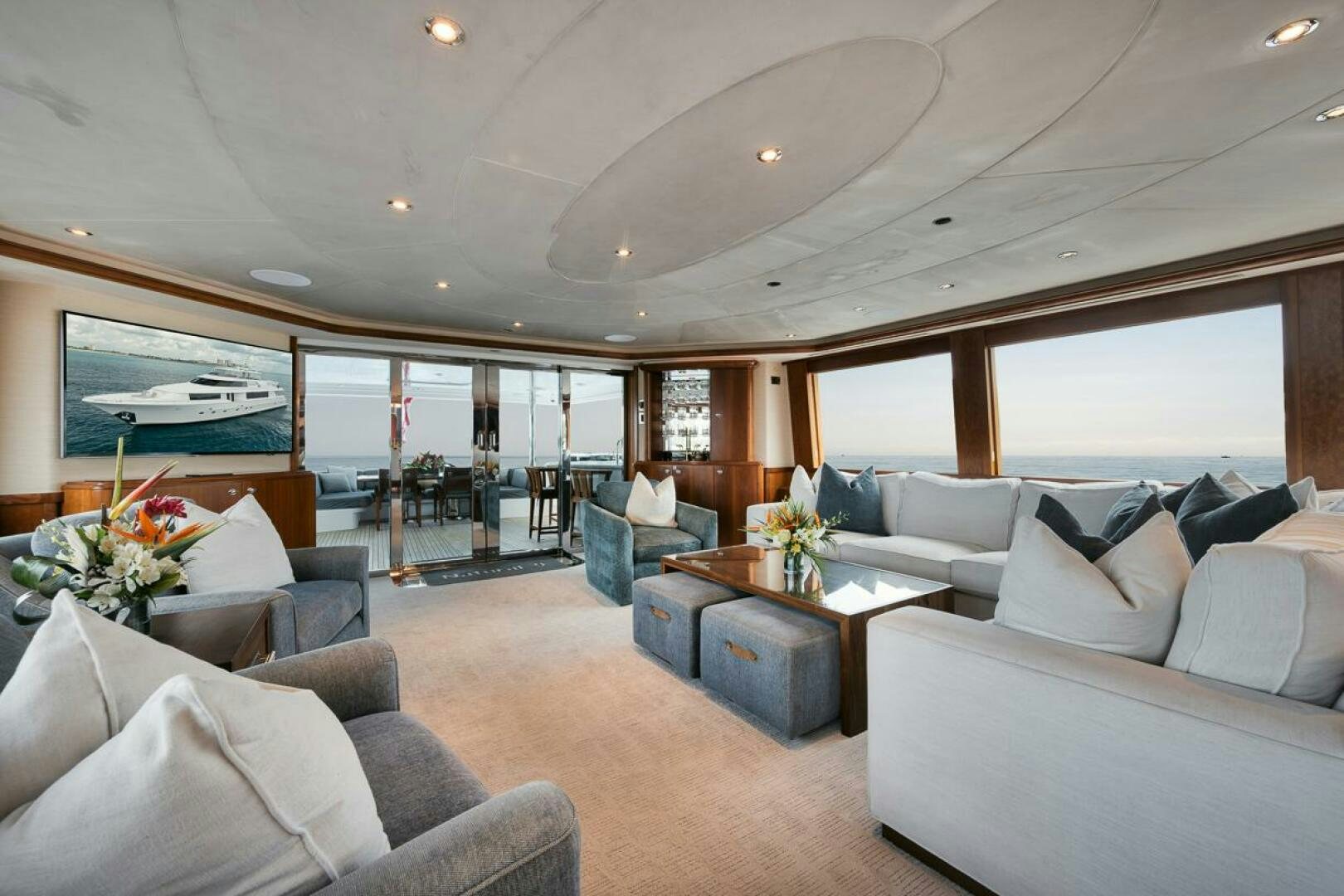 a living room with a large window aboard NATURAL 9 X KALEEN Yacht for Sale