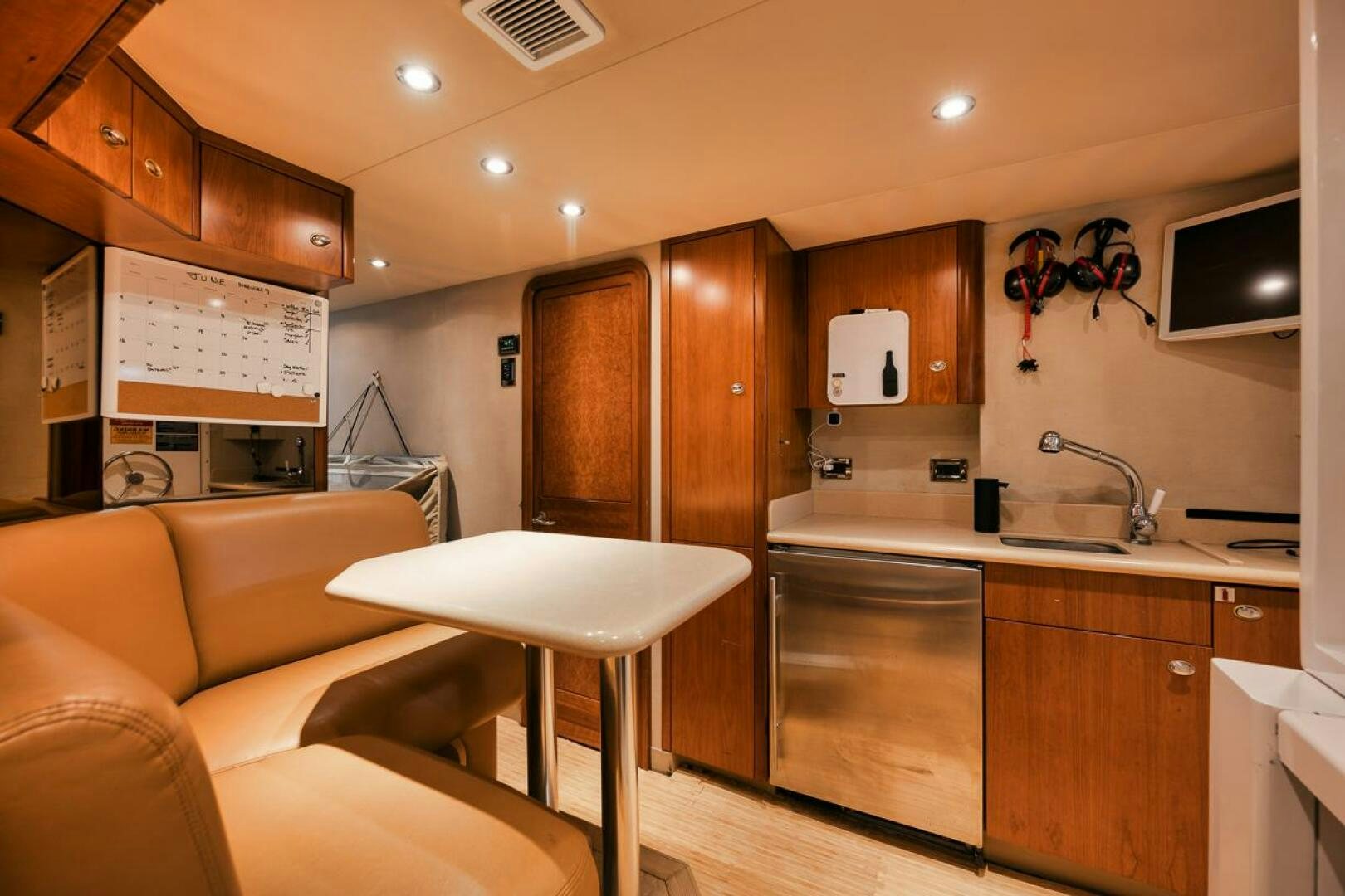a kitchen with a sink and a couch aboard NATURAL 9 X KALEEN Yacht for Sale