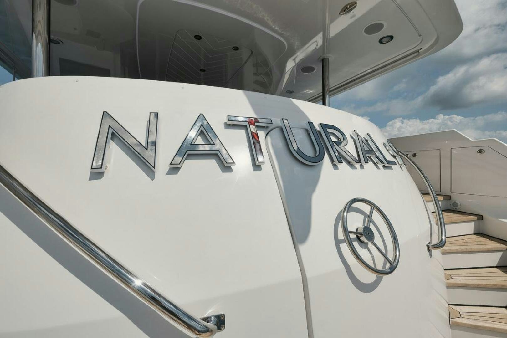 a white boat with black text aboard NATURAL 9 X KALEEN Yacht for Sale
