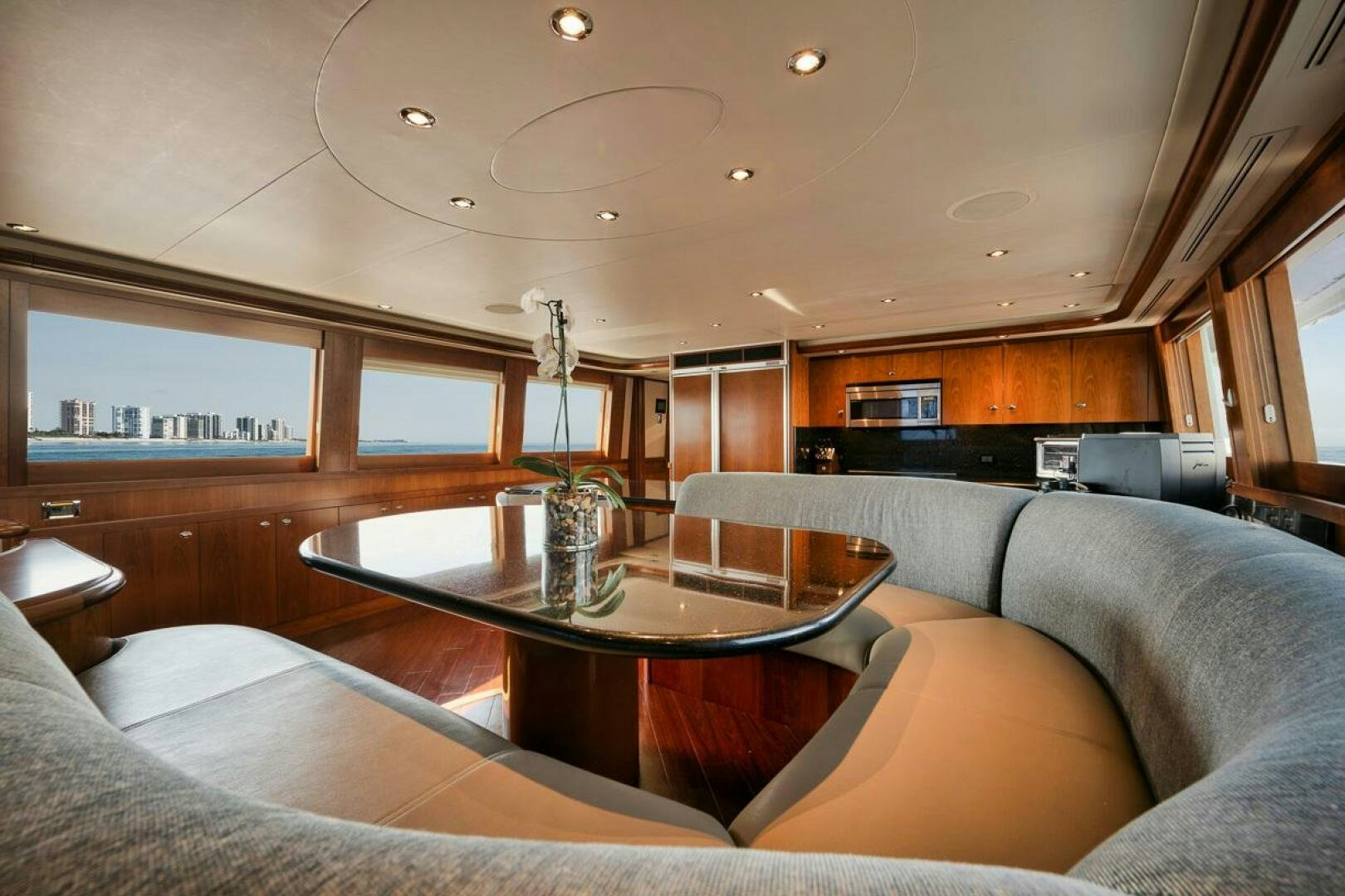 a living room with a table aboard NATURAL 9 X KALEEN Yacht for Sale