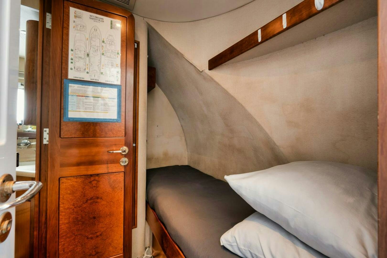 a bed with a wooden frame aboard NATURAL 9 X KALEEN Yacht for Sale