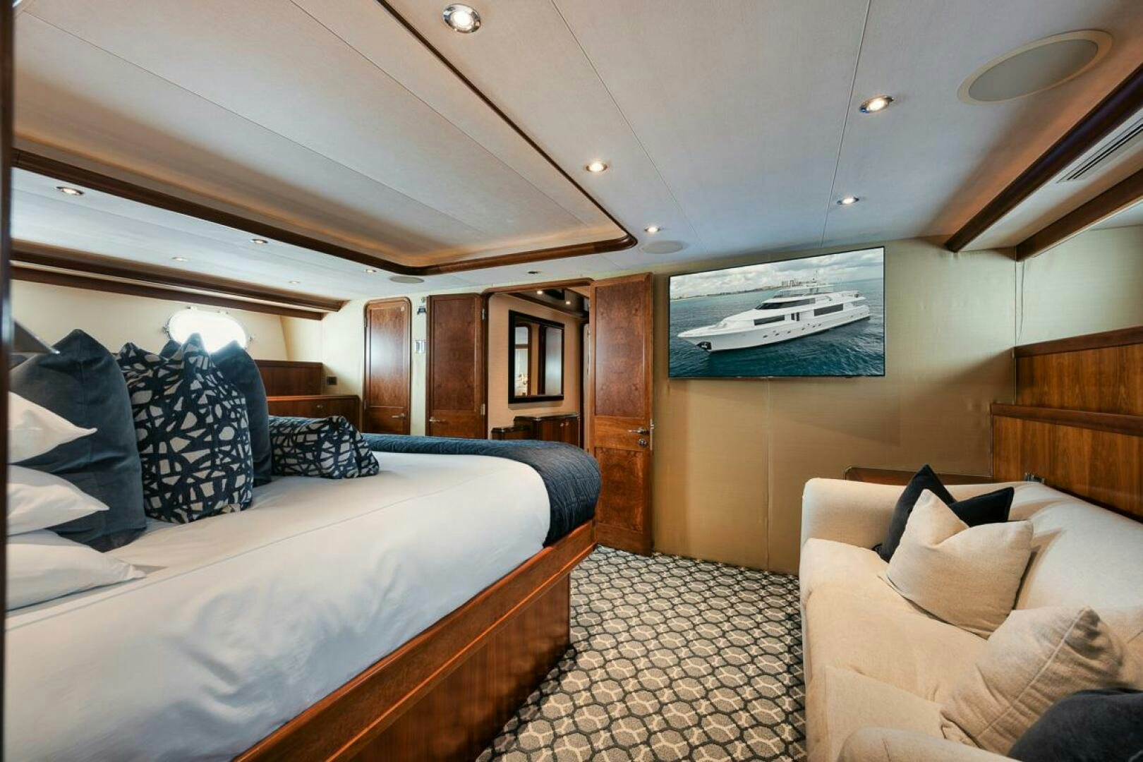 a room with a bed and a couch aboard NATURAL 9 X KALEEN Yacht for Sale